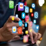 person-using-cell-phone-with-facebook-screen